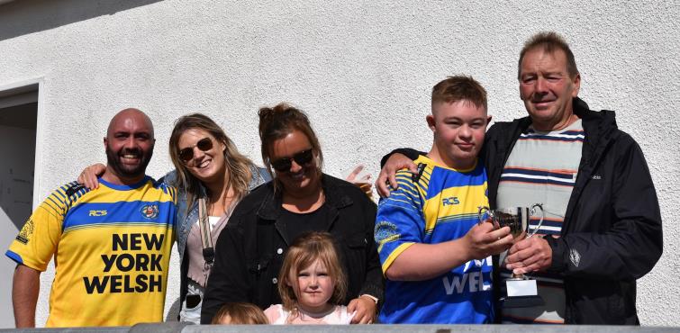 Bleddyn Gibbs receives the trophy from the Harries family